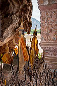 Luang Prabang, Laos - The Pak Ou Caves, the lower cave called Tham Ting. The caves, a Buddhist pilgrimage site, are a repository of old Buddha statues.